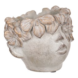 Obal na květiny betonový, tvar hlavy, barva kytek měděná.