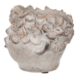 Obal na květiny betonový, tvar hlavy, barva kytek měděná.