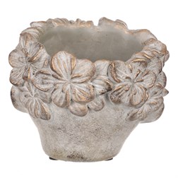 Obal na květiny betonový, tvar hlavy, barva kytek měděná.